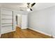 Bright bedroom with hardwood floors, built-in shelving, and closet access at 1002 Defoors Nw Lndg, Atlanta, GA 30318