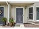 Close up of unit number 1002's front door with potted plants and hardware at 1002 Defoors Nw Lndg, Atlanta, GA 30318