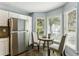 Cozy kitchen featuring stainless steel refrigerator and breakfast nook at 1002 Defoors Nw Lndg, Atlanta, GA 30318