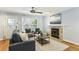 Cozy living room with a fireplace, ceiling fan, and comfortable seating at 1002 Defoors Nw Lndg, Atlanta, GA 30318