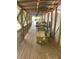 Extended covered porch with wood flooring and railings, offering ample space for outdoor seating and storage at 36 Wolf Pen Path, Dallas, GA 30157