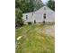 View of the rear side of the home with light gray vinyl siding and a well-maintained yard at 36 Wolf Pen Path, Dallas, GA 30157