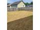Fenced backyard with sparse grass and a long shadow across the yard at 948 Regency Dr, Lawrenceville, GA 30044