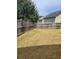Large backyard featuring a wooden fence, offering privacy and space for outdoor activities at 948 Regency Dr, Lawrenceville, GA 30044