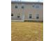 View of the rear exterior of the home and backyard with a grassy area at 948 Regency Dr, Lawrenceville, GA 30044