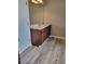 Bathroom featuring a wooden vanity with a granite countertop and laminate wood flooring at 948 Regency Dr, Lawrenceville, GA 30044