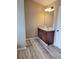 Bathroom featuring a dark wood vanity with granite countertop, undermount sink, and laminate wood flooring at 948 Regency Dr, Lawrenceville, GA 30044