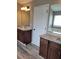 Bright bathroom featuring dual vanities with granite countertops, tub and laminate wood flooring at 948 Regency Dr, Lawrenceville, GA 30044