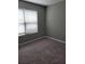 Bedroom featuring neutral walls, plush carpeting, and bright light from a window at 948 Regency Dr, Lawrenceville, GA 30044