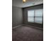 Sunlit bedroom featuring neutral walls, modern window blinds, and soft carpeting at 948 Regency Dr, Lawrenceville, GA 30044
