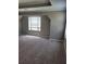 Neutral bedroom with plush carpet and large window, filling the room with natural light at 948 Regency Dr, Lawrenceville, GA 30044