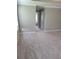 Well-lit bedroom with neutral walls, plush carpet, a door, and a view to another room at 948 Regency Dr, Lawrenceville, GA 30044