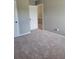 Carpeted bedroom with doors leading to other rooms in the house at 948 Regency Dr, Lawrenceville, GA 30044