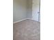 Bedroom with neutral walls, plush carpeting, and a bright white door at 948 Regency Dr, Lawrenceville, GA 30044