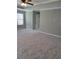 Bright bedroom featuring plush carpeting, neutral paint, and a ceiling fan at 948 Regency Dr, Lawrenceville, GA 30044