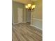 Cozy dining area with stylish wood-style laminate floors and an inviting arched doorway at 948 Regency Dr, Lawrenceville, GA 30044