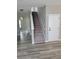 Welcoming foyer with a staircase, archway, neutral walls, and hardwood flooring at 948 Regency Dr, Lawrenceville, GA 30044