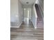 Bright foyer featuring hardwood floors, a staircase, and an archway leading to another room at 948 Regency Dr, Lawrenceville, GA 30044