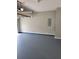 Clean two-car garage with epoxy flooring and gray walls at 948 Regency Dr, Lawrenceville, GA 30044