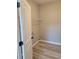 Well-lit laundry room featuring vinyl flooring and a wire shelf at 948 Regency Dr, Lawrenceville, GA 30044