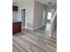 Open-concept home featuring gray walls, hardwood flooring, stairs, and kitchen access at 948 Regency Dr, Lawrenceville, GA 30044
