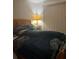 Bedroom with a wood frame bed, nightstand, lamp, and window with blinds at 2977 Lowe Ne Trl, Marietta, GA 30066
