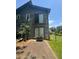 Rear exterior view of property with a concrete patio area and upper level door at 2977 Lowe Ne Trl, Marietta, GA 30066