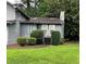 Two-story home with neutral siding and manicured hedges at 2977 Lowe Trail Ne Trl, Marietta, GA 30066