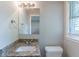 The bathroom features a white sink, granite countertops, and a window for natural light at 4230 Cheryl Ann Ct, Stone Mountain, GA 30083