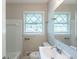 Bathroom featuring a toilet, sink and vanity, mirror, and a shower and tub with tile surround at 4230 Cheryl Ann Ct, Stone Mountain, GA 30083
