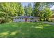 Charming single-story home with lush green lawn and mature trees at 4230 Cheryl Ann Ct, Stone Mountain, GA 30083