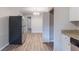 Stainless steel refrigerator and a glimpse into another room featuring neutral paint and wood flooring at 4230 Cheryl Ann Ct, Stone Mountain, GA 30083