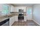 The kitchen has white cabinets, granite countertops, and stainless steel appliances, including a microwave and oven at 4230 Cheryl Ann Ct, Stone Mountain, GA 30083