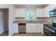 View of a kitchen featuring stainless steel appliances, granite countertops, and white cabinets and a dishwasher at 4230 Cheryl Ann Ct, Stone Mountain, GA 30083
