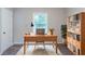 Bright home office with a large desk, ample storage, and a cozy rug at 4230 Cheryl Ann Ct, Stone Mountain, GA 30083
