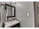 This bathroom features a single sink, a framed mirror, and modern fixtures at 5105 Vernon Oaks Dr, Dunwoody, GA 30338