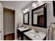 This bathroom boasts a double vanity with framed mirrors and is equipped with modern fixtures at 5105 Vernon Oaks Dr, Dunwoody, GA 30338