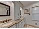 Bright bathroom featuring double sinks, granite countertops, custom cabinetry and a decorative mirror at 5105 Vernon Oaks Dr, Dunwoody, GA 30338