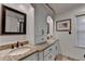 Bathroom with double sinks, granite countertops, decorative mirror, and custom white cabinets at 5105 Vernon Oaks Dr, Dunwoody, GA 30338