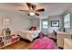 A modern bedroom with a fan, bright rug, white furniture, and wood floors at 5105 Vernon Oaks Dr, Dunwoody, GA 30338