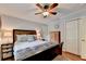 Relaxing bedroom featuring a ceiling fan, closet, a bedside table, and a wooden armoire at 5105 Vernon Oaks Dr, Dunwoody, GA 30338