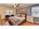 Comfortable bedroom features stylish decor, hardwood floors, ceiling fan, and an abundance of natural light at 5105 Vernon Oaks Dr, Dunwoody, GA 30338