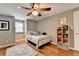 Neutral bedroom with a ceiling fan, window, throw rug, shelving and hardwood floors at 5105 Vernon Oaks Dr, Dunwoody, GA 30338