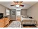 Neutral bedroom with a ceiling fan, window, throw rug, a dresser, and hardwood floors at 5105 Vernon Oaks Dr, Dunwoody, GA 30338