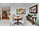 Dining area with bright light, tile floors, view through archway into updated kitchen, and view of living area at 5105 Vernon Oaks Dr, Dunwoody, GA 30338