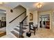 Bright foyer with staircase, tile flooring, and decor leading to a living room area with nice furniture at 5105 Vernon Oaks Dr, Dunwoody, GA 30338