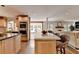 Modern kitchen featuring stainless steel appliances, an island, a breakfast bar, and seamless connection to the living area at 5105 Vernon Oaks Dr, Dunwoody, GA 30338