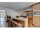 Modern kitchen with breakfast bar seating, hardwood floors, stainless steel appliances and light wood cabinetry at 5105 Vernon Oaks Dr, Dunwoody, GA 30338
