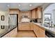 Bright kitchen features stainless steel appliances, light wood cabinets, and a kitchen island with a dark countertop at 5105 Vernon Oaks Dr, Dunwoody, GA 30338
