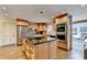 Bright kitchen features stainless steel appliances, center island with dark countertop, and light wood cabinets at 5105 Vernon Oaks Dr, Dunwoody, GA 30338